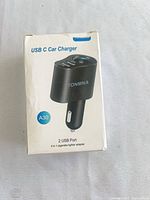 Front of Tonmna A30 car charger retail box showing product image and dual USB specification