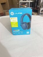 Front of boxed JLab JBuddies Protect blue earmuffs