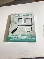 Front of sealed box showing model 6185, 48 LED, cold and warm switchable light