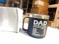 Front view showing navy mug with DAD Nutrition Facts design beside box