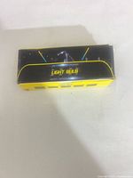Top view of yellow and black box labelled "LIGHT BULB"