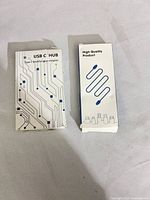 Front view of two USB-C hub boxes showing product graphics and titles