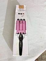 Front of box showing pink triple-barrel curler and model code