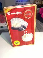 Front of Minijoy popcorn maker box showing product image and oil-free claim