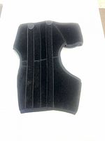 Exterior of black wrap knee brace showing vertical stabilizer strips