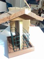 Front angle showing roof, seed tray and twin green suet cages