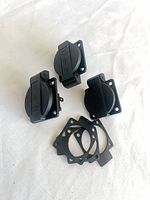 Front view of three IEC inlet connectors with covers and gaskets