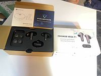Retail box opened showing earbuds, ear tips, quick start guide and outer sleeve