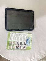 front view of tablet case next to instruction card