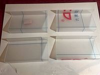 Four clear acrylic shelves on white background with protective film