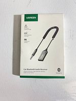 Front of sealed box showing product image and specs