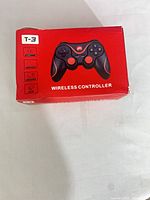Front of red retail box showing image of black and red T-3 controller