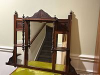 Full view of mirror showing three panels, crest, shelves, spindle supports