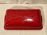 lid exterior showing raised lettering and logo