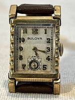 Front view of Bulova rectangular watch showing dial, bezel and strap