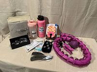 Overall lot showing hoop, bottles, cleaners, sleeves, combs, drink holder