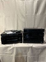 Overall view of all stacked components with remotes and manual