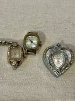 Front view of three watches showing dials, shapes, and bracelet.