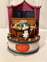 Front view showing cat figure, piano, stage drapes and Follies Music Hall label