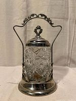 Front view of pickle castor showing cut glass jar and silverplate stand