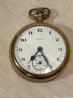Front view of Elgin pocket watch showing dial and hands