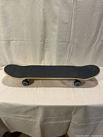 Top view of skateboard showing black grip tape deck