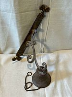 Bell attached to bracket showing overall design