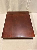 Closed wooden lap desk top view