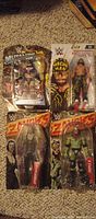 Front view of all four sealed WWE figures