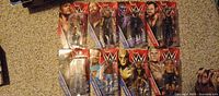 Front view of all eight sealed WWE figures on card