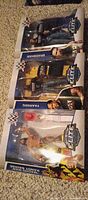 Front view of three sealed WWE Elite figures in boxes