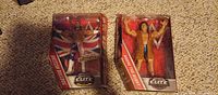 Front view of both sealed WWE Elite figures in boxes