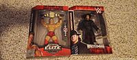 Front view of boxed John Cena and Undertaker figures