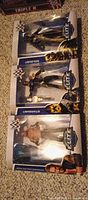 Front view of three sealed WWE Elite Series 36 figures stacked