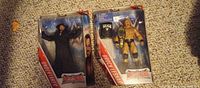 Front view of both sealed Undertaker and Brock Lesnar WrestleMania Elite figures in packaging