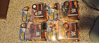 Front view of the four sealed WWE Hot Wheels Monster Trucks