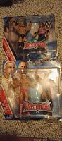 Front view of both sealed battle packs showing figures and WrestleMania branding