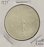 Reverse of 1975 Canada $5 coin showing Marathon runner design and Olympic inscriptions