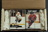 Open box showing two stacks of hockey cards, front cards Glen Wesley and Play Smart visible