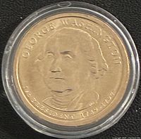 Obverse of 2007 George Washington Presidential dollar in capsule