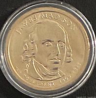 Obverse of 2007 James Madison $1 coin in capsule
