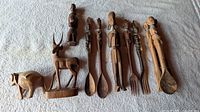 Group shot of all carvings and utensils on white cloth