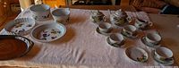 Full lot overview on table: four Evesham dishes, brown platter, Asian tea set