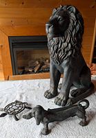 Group shot of lion statue, dachshund boot scraper, turtle trivet
