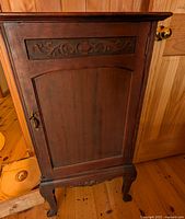 Front view of wood cabinet closed