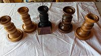 Group of five candle holders showing finishes and design