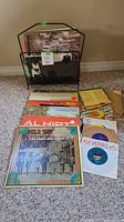 Wire rack holding LPs; additional LPs and 45s laid out in front