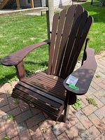 Full view of brown HDPE Adirondack chair on patio