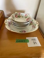 stack of six bowls nested inside larger handled serving bowl