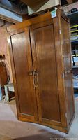 front view of closed wooden 2-door wardrobe